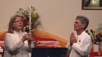 Ministers holding candle